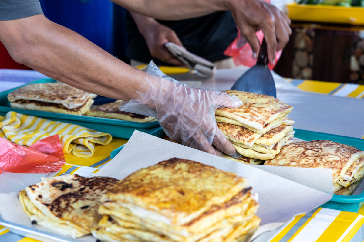Seller preparing murtabak at street stall for iftar during Ramad