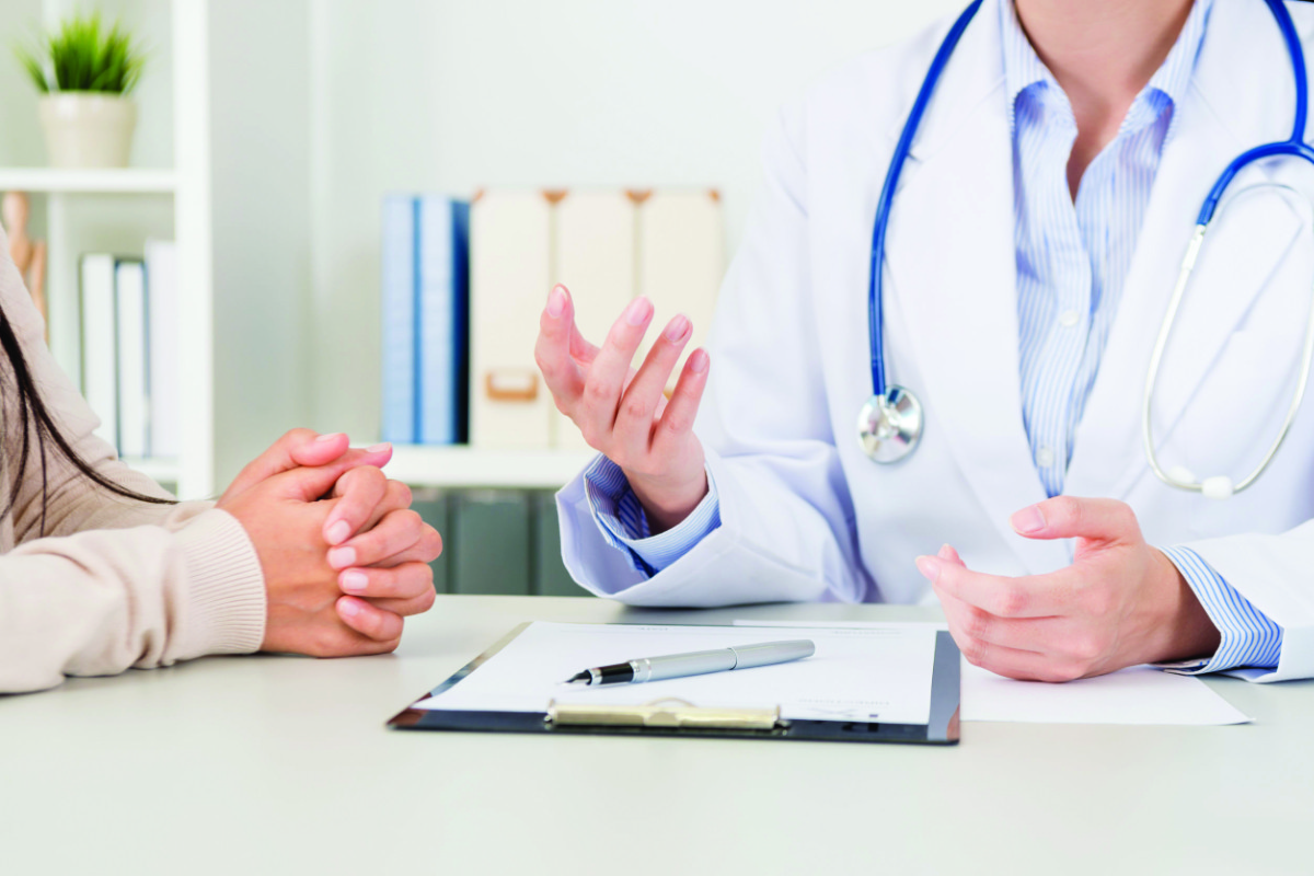 closeup of female doctor explain disease treatment solution for patient in clinic. selective focus photo.